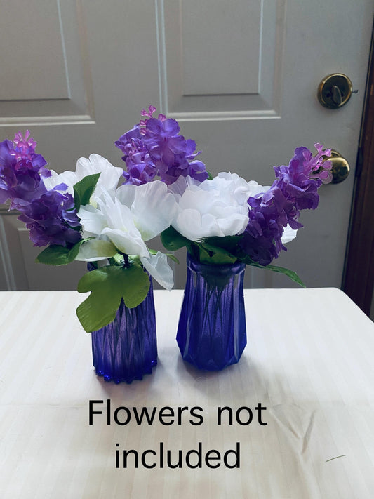 Set of two small hand-crafted purple resin vases.