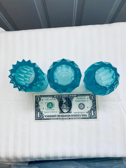 Set of three small hand-crafted teal resin vases.
