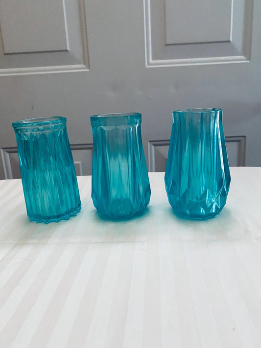 Set of three small hand-crafted teal resin vases.