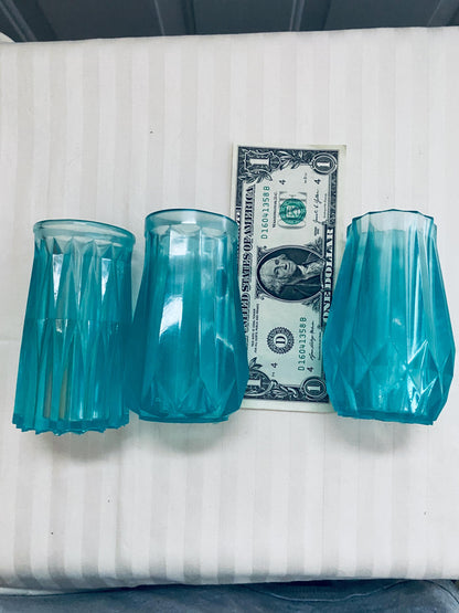 Set of three small hand-crafted teal resin vases.