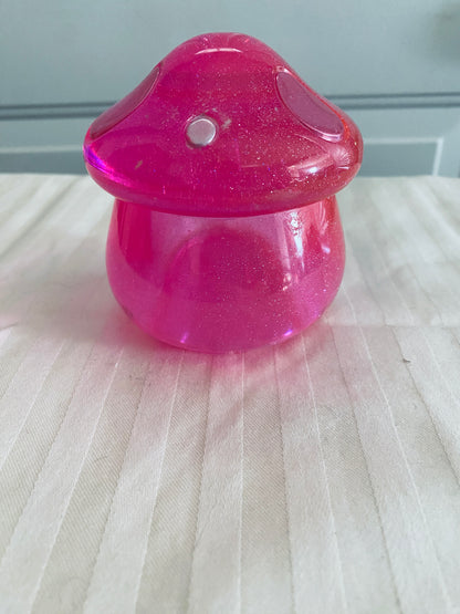 Pink mushroom-shaped pot with lid.