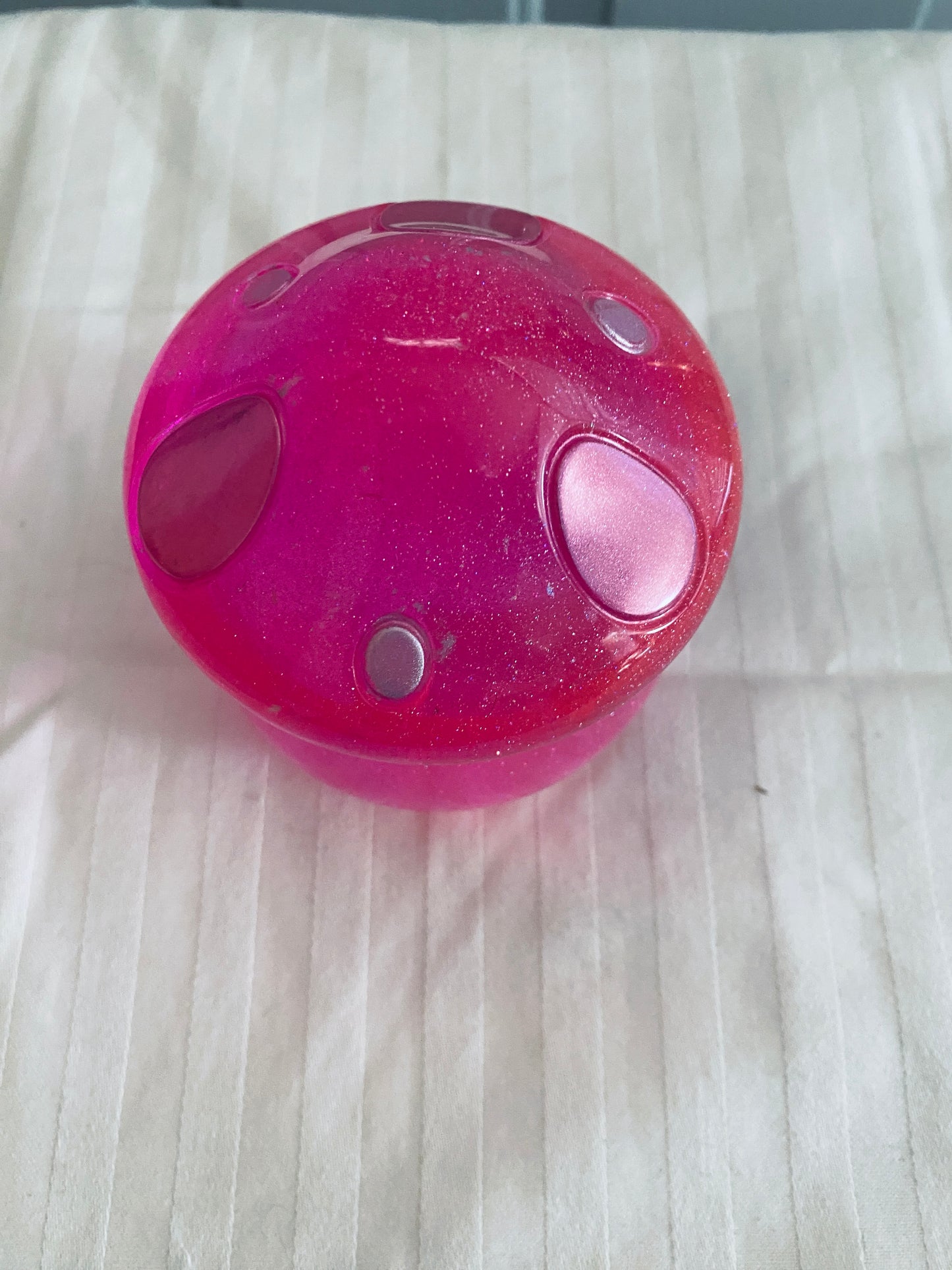 Pink mushroom-shaped pot with lid.