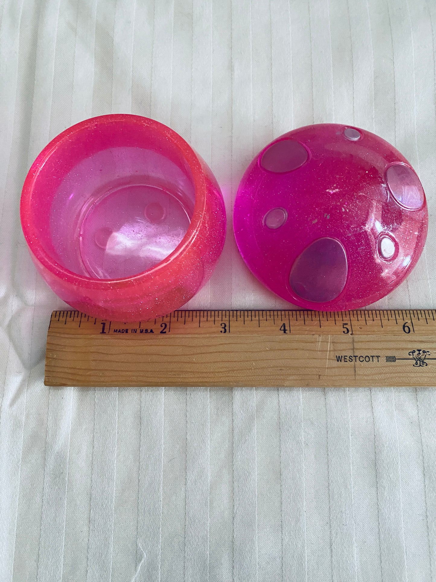 Pink mushroom-shaped pot with lid.