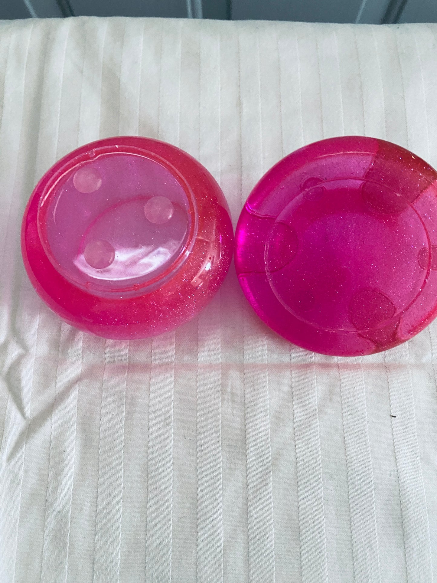 Pink mushroom-shaped pot with lid.