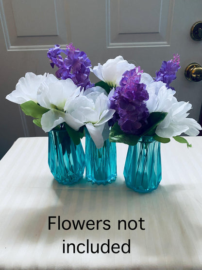 Set of three small hand-crafted teal resin vases.